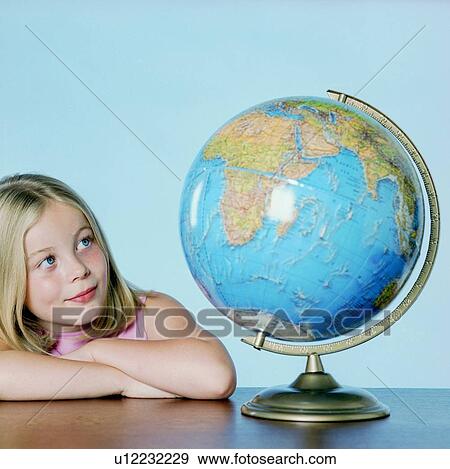 Girl looking at a globe View Large Photo Image Stock Photo - Girl looking at a globe. Fotosearch