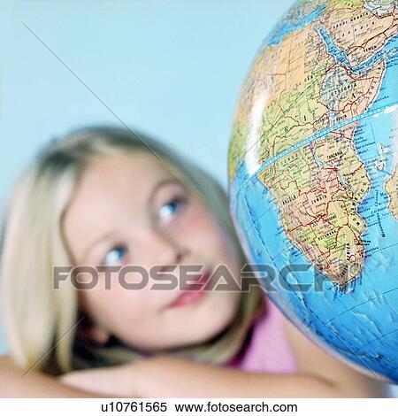 Girl looking at a globe View Large Photo Image Stock Photography - Girl looking at a globe. Fotosearch