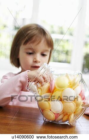 Stock Image - Girl taking sweets. Fotosearch