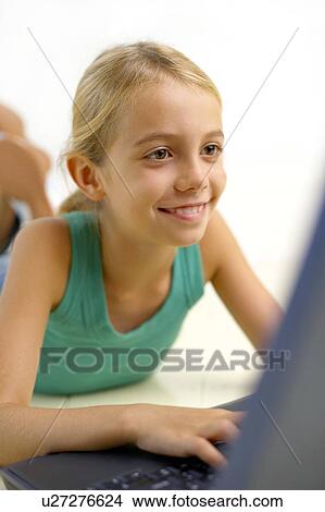 Picture - Girl using a laptop computer. Fotosearch