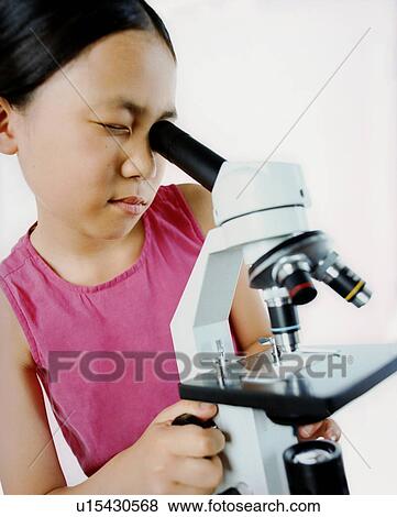 Girl using a microscope View Large Photo Image Stock Photo - Girl using a microscope. Fotosearch
