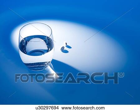 Picture - Glass of water and pills. Fotosearch