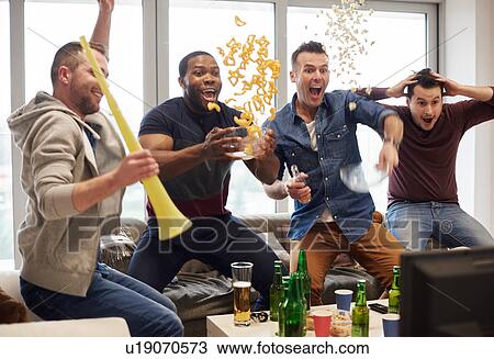 Group of men watching sport event on television celebrating View Large Photo Image Stock Image - Group of men watching sport event on television celebrating. Fotosearch
