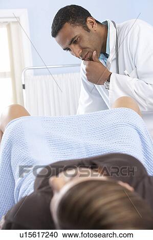 Gynaecologist during an examination View Large Photo Image Stock Image - Gynaecologist during an examination. Fotosearch
