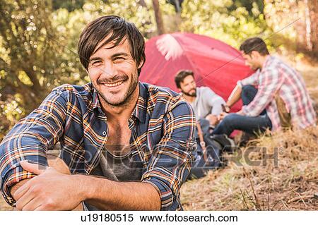 Happy mid adult man and friends camping in forest, Deer Park, Cape Town, South Africa View Large Photo Image Stock Photography - Happy mid adult man and friends camping in forest, Deer Park, Cape Town, South Africa. Fotosearch