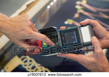 High angle cropped view of womans hand using chip and pin machine View Large Photo Image Stock Image - High angle cropped view of womans hand using chip and pin machine. Fotosearch