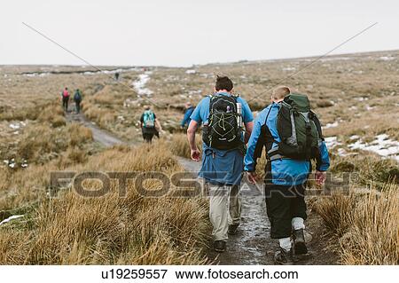 Hikers crossing moor, Yorkshire Dales National Park, England View Large Photo Image Stock Photo - Hikers crossing moor, Yorkshire Dales National Park, England. Fotosearch