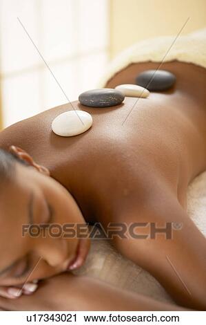 Stock Image - Hot Stone therapy. Fotosearch