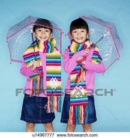 Stock Photo - Identical twin sisters. Fotosearch