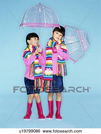 Stock Photograph - Identical twin sisters. Fotosearch