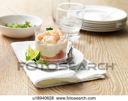 Stock Photo - King prawn and salmon starter with lime wedge. Fotosearch