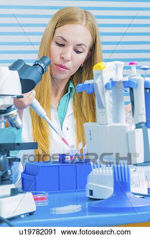 Lab assistant analysing blood samples View Large Photo Image Stock Image - Lab assistant analysing blood samples. Fotosearch