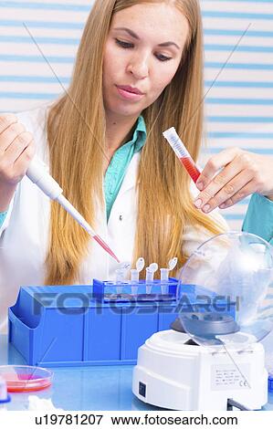 Stock Photo - Lab assistant analysing blood samples. Fotosearch