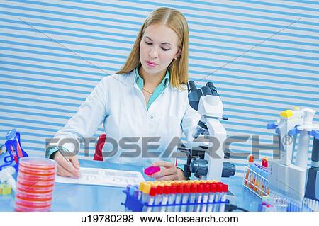 Lab assistant holding sample View Large Photo Image Stock Photo - Lab assistant holding sample. Fotosearch