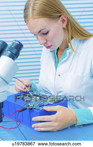 Stock Photo - Lab assistant testing printed circuit. Fotosearch