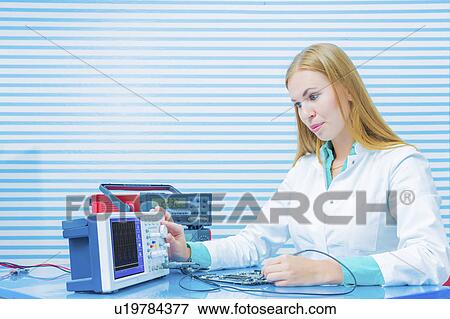 Stock Photo - Lab assistant testing printed circuit. Fotosearch