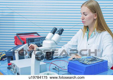 Stock Photography - Lab assistant testing printed circuit. Fotosearch