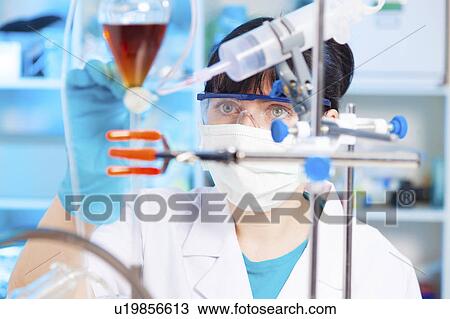 Lab technician doing experiment View Large Photo Image Stock Image - Lab technician doing experiment. Fotosearch