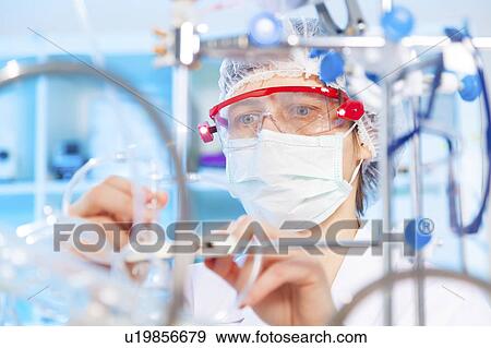 Lab technician doing experiment View Large Photo Image Stock Photo - Lab technician doing experiment. Fotosearch