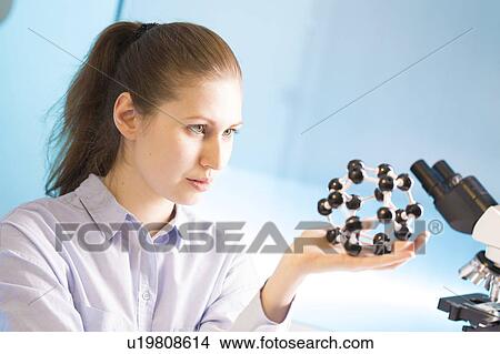Lab technician holding atomic model View Large Photo Image Picture - Lab technician holding atomic model. Fotosearch