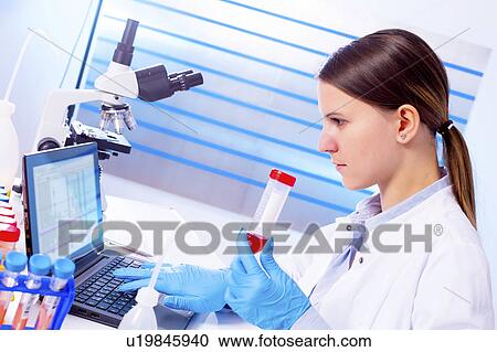 Lab technician holding test tube in lab View Large Photo Image Stock Image - Lab technician holding test tube in lab. Fotosearch