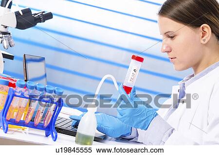 Stock Photography - Lab technician holding test tube in lab. Fotosearch