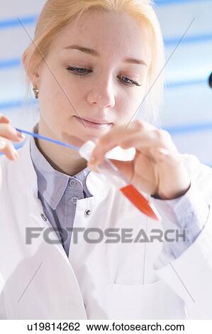 Lab technician holding test tube View Large Photo Image Stock Image - Lab technician holding test tube. Fotosearch