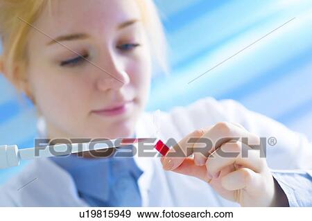 Lab technician holding test tube View Large Photo Image Stock Photo - Lab technician holding test tube. Fotosearch