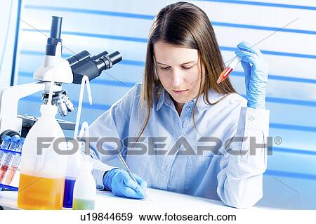Lab technician making notes in lab View Large Photo Image Stock Photo - Lab technician making notes in lab. Fotosearch