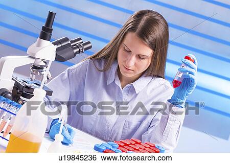 Lab technician making notes in lab View Large Photo Image Stock Photograph - Lab technician making notes in lab. Fotosearch