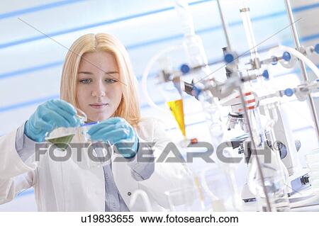 Stock Photography - Lab technician pouring chemical. Fotosearch