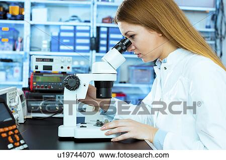Lab technician using microscope View Large Photo Image Stock Image - Lab technician using microscope. Fotosearch