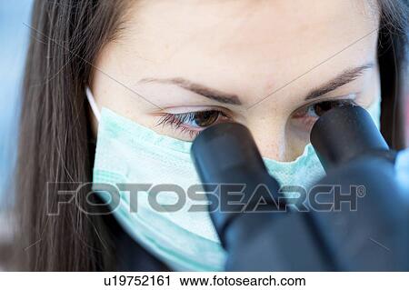 Lab technician using microscope View Large Photo Image Stock Image - Lab technician using microscope. Fotosearch