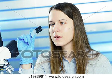 Lab technician using microscope View Large Photo Image Stock Image - Lab technician using microscope. Fotosearch