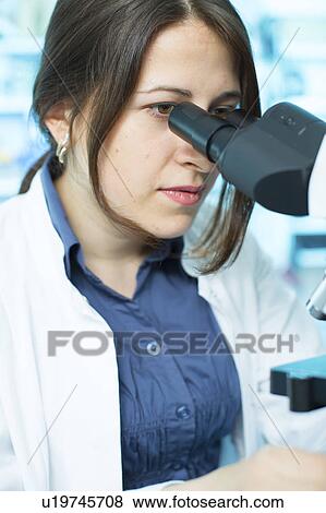 Lab technician using microscope View Large Photo Image Stock Photo - Lab technician using microscope. Fotosearch