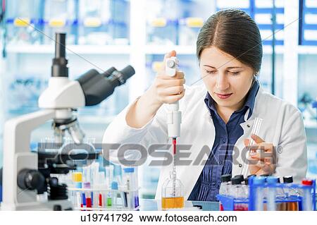Lab technician using pipette View Large Photo Image Stock Image - Lab technician using pipette. Fotosearch