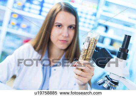 Stock Photography - Lab technician with legumes. Fotosearch
