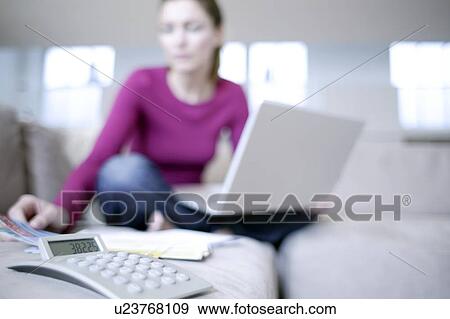 Stock Photo - Laptop and calculator use. Fotosearch