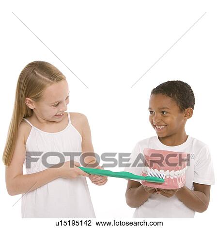 Stock Image - Learning dental hygiene. Fotosearch