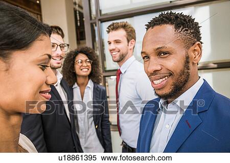 Male and female business team having discussion outside office View Large Photo Image Stock Photography - Male and female business team having discussion outside office. Fotosearch