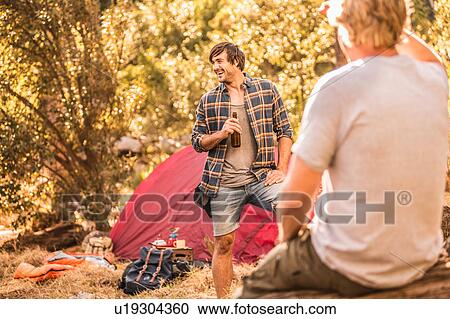 Male campers chatting and drinking beer in forest, Deer Park, Cape Town, South Africa View Large Photo Image Stock Image - Male campers chatting and drinking beer in forest, Deer Park, Cape Town, South Africa. Fotosearch