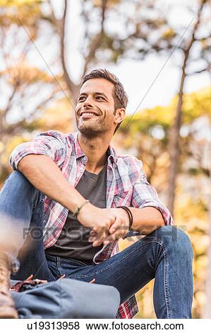 Stock Photo - Male hiker taking a break in forest, Deer Park, Cape Town, South Africa. Fotosearch