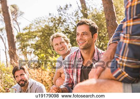 Male hiking friends chatting in forest, Deer Park, Cape Town, South Africa View Large Photo Image Stock Photo - Male hiking friends chatting in forest, Deer Park, Cape Town, South Africa. Fotosearch
