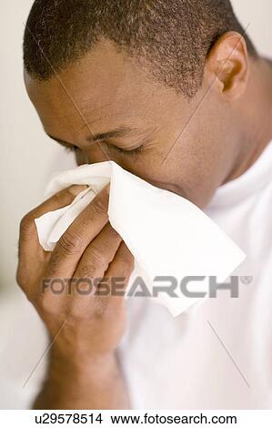 Man blowing his nose View Large Photo Image Picture - Man blowing his nose. Fotosearch