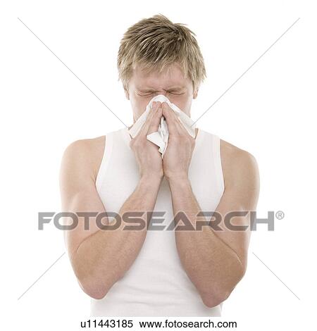 Stock Photography - Man blowing his nose. Fotosearch