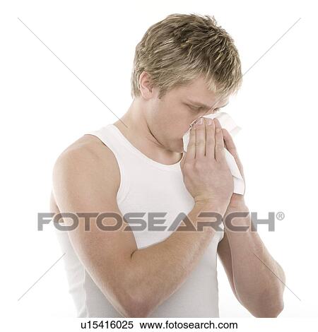 Stock Photography - Man blowing his nose. Fotosearch