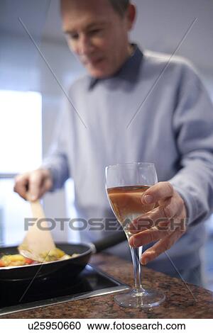 Stock Image - Man cooking. Fotosearch