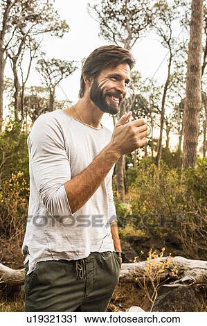 Man drinking coffee in forest, Deer Park, Cape Town, South Africa View Large Photo Image Stock Image - Man drinking coffee in forest, Deer Park, Cape Town, South Africa. Fotosearch