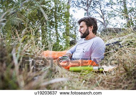 Man gazing from sleeping bag in forest, Deer Park, Cape Town, South Africa View Large Photo Image Stock Photo - Man gazing from sleeping bag in forest, Deer Park, Cape Town, South Africa. Fotosearch