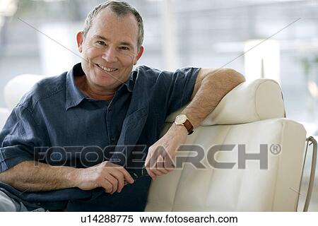 Stock Photography - Man holding his glasses. Fotosearch